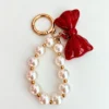 Pearl charm with red bow
